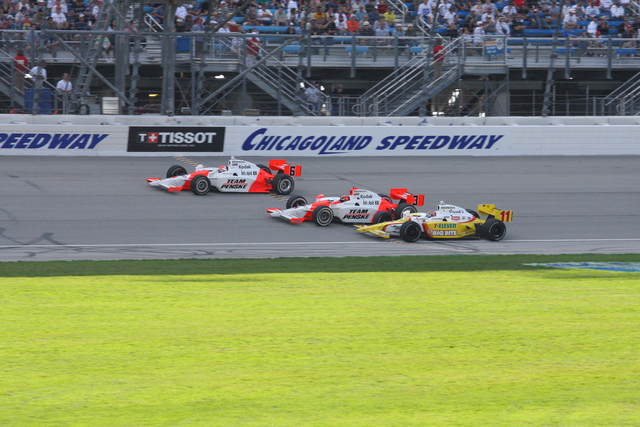 No. 6 Ryan Briscoe, No. 3 Helio Castroneves and No. 11 Tony Kanaan battle it out during the PEAK Antifreeze & Motor Oil Indy 300 at Chicagoland Speedway. -- Photo by: Shawn Payne