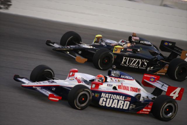 Teammates Wheldon and Carpenter run side by side during the PEAK Antifreeze and Motor Oil Indy 300 -- Photo by: Dan Helrigel
