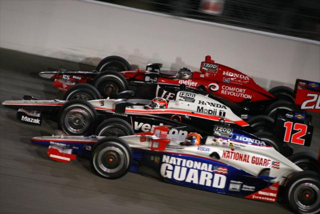 Wheldon, Power, and Andretti go three wide -- Photo by: Dan Helrigel
