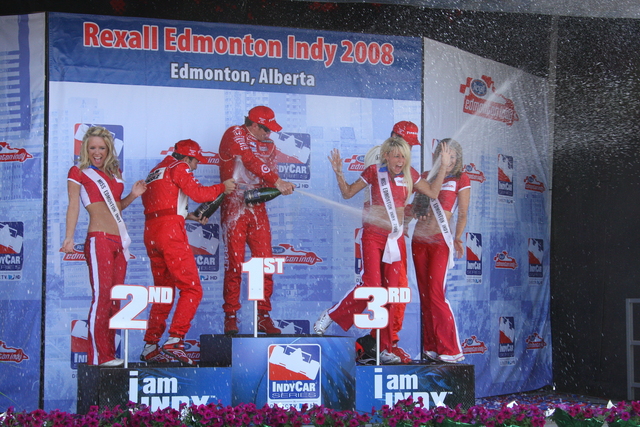 Helio Castroneves, Scott Dixon and Justin Wilson celebrate on the podium after the race at Edmonton. -- Photo by: Shawn Payne