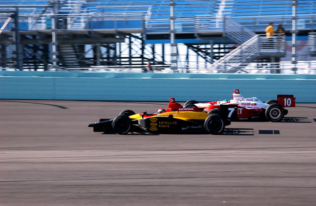 Bryan Herta in the # 7 car TBA Dallara Honda ; and Darren Manning in the # 10 car Target Chip Ganassi Racing Panoz G-Force Toyota on the track at Homestead-Miami during the Toyota 300 -- Photo by: Dana Garrett