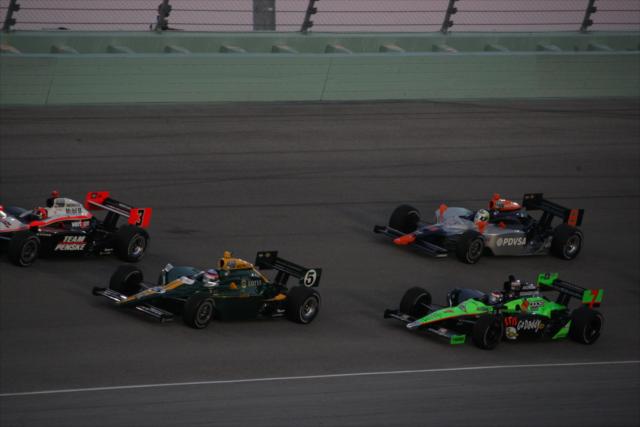 A crowded track with Castroneves, Sato, Patrick and Viso all racing. -- Photo by: Chris Jones
