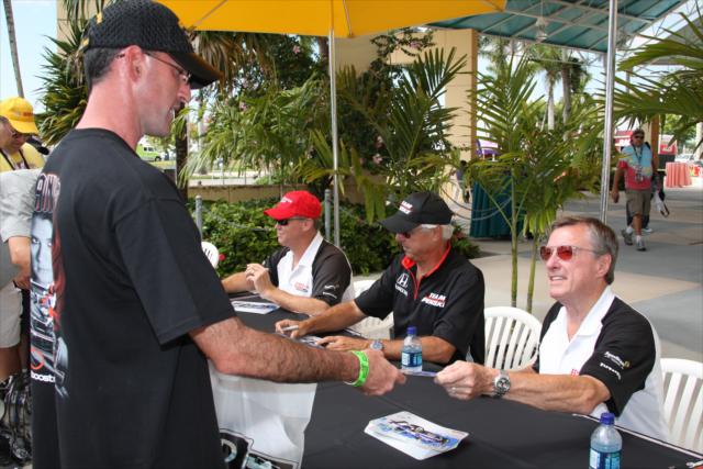 Johnny Rutherford, Rick Mears and Al Unser Jr. sign for fans. -- Photo by: Dana Garrett