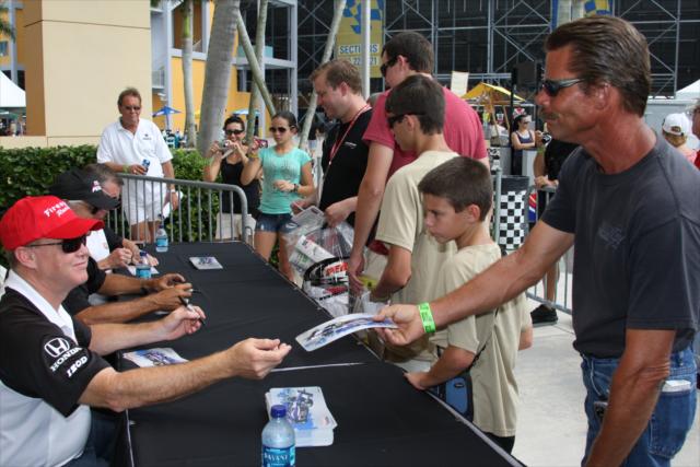 Al Unser Jr. signs for fans. -- Photo by: Dana Garrett