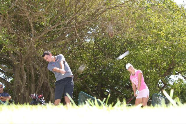 Graham Rahal and Beatriz Recari play some golf. -- Photo by: Ron McQueeney