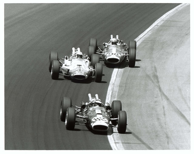 Jim Clark, #82, Lotus powered by Ford, Lotus, Ford leads A.J. Foyt, #1, Sheraton-Thompson, Lotus, Ford and Parnelli Jones, #98, Agajanian Hurst, Kuzma-Lotus, Ford during 1965 Indianapolis 500. -- Photo by: No Photographer