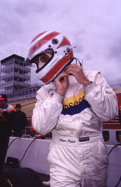 Driver Nelson Piquet straps on his helmet. -- Photo by: No Photographer