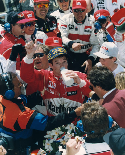 Unser Jr. celebrates his second Indianapolis 500 win in Victory Lane, enjoying the traditional drink of cold milk.  -- Photo by: No Photographer