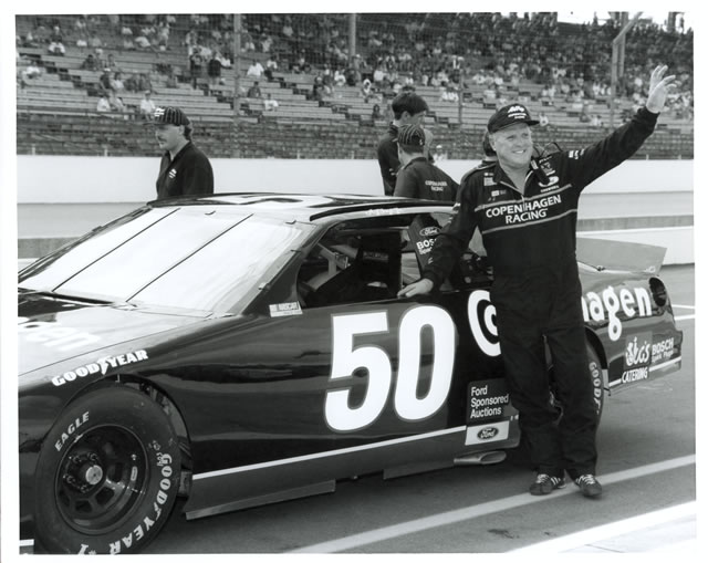 A.J. Foyt waves to the crowed beside his #50 Copenhagen Ford prior to the inaugural Brickyard 400. -- Photo by: No Photographer