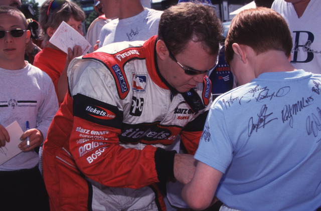 Two-time Indianapolis 500 champion Al Unser Jr., signs an autograph for a fan. -- Photo by: No Photographer