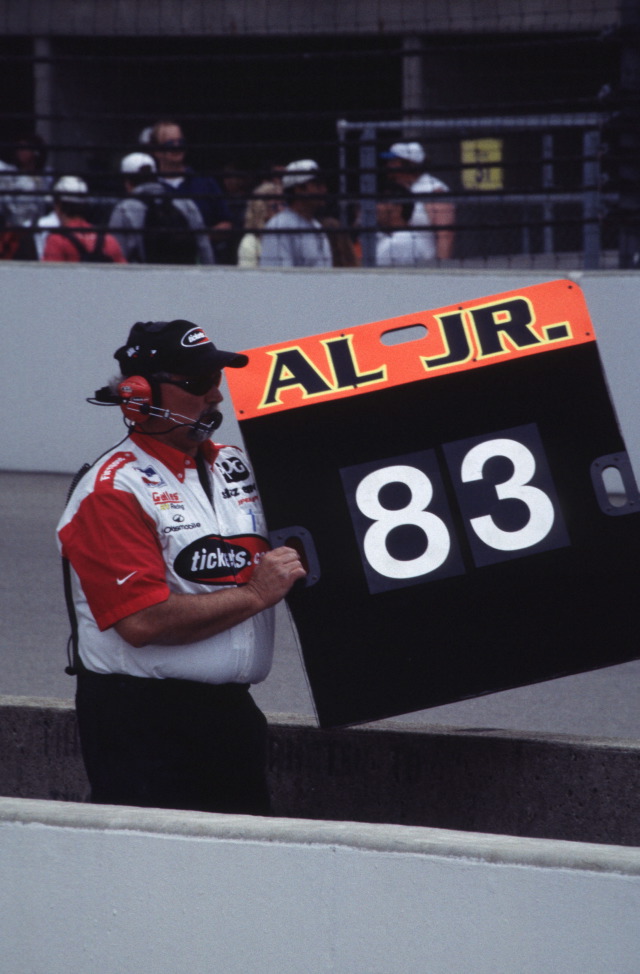 A crew member shows Al Unser Jr. his lap time. -- Photo by: No Photographer