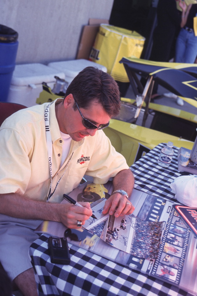 Scott Goodyear, driver of the #4, Pennzoil Panther Dallara, Dallara, Oldsmobile, signs autographs at the Indianapolis Motor Speedway. -- Photo by: No Photographer