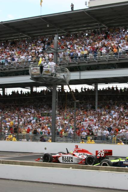 Dan Wheldon takes the checkered flag to win the 89th running of the indianpolis 500 at the Indianapolis Motor Speedway. -- Photo by: Dan Helrigel