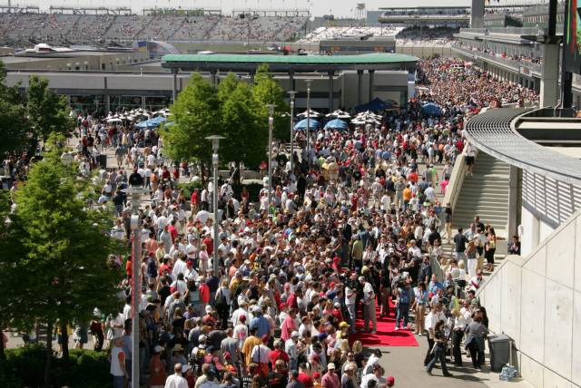 Fans gather to watch celebrities walk the red carpet before the 89th running of the Indianpolis 500 at the Indianapolis Motor Spedway. -- Photo by: Michael Voorhees