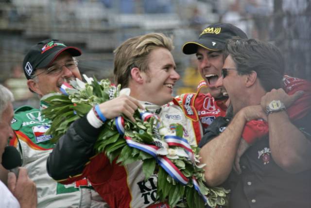 Dan Wheldon celebrates with teammate Bryan Herta and car owners Kim Green and Micheal Andretti after winning the 89th running of the Indianapolis 500 at the Indianapolis Motor Speedway.  -- Photo by: Michael Voorhees