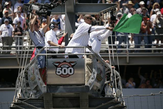 Indiana Pacers great Reggie Miller waves the green flag to begin the 89th running of the Indianapolis 500. -- Photo by: Michael Voorhees