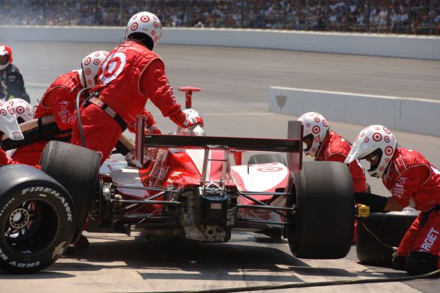 Dan Wheldon's No. 10 Target Chip Ganassi Racing Team car receives a change of tires and some fuel during a pit stop at the 90th running of the Indianapolis 500. -- Photo by: Dana Garrett