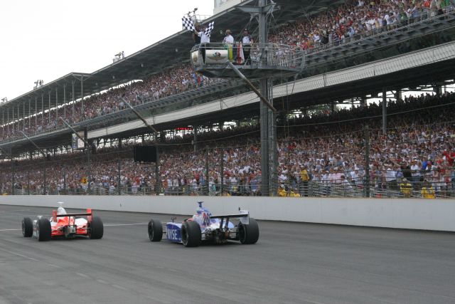Sam Hornish Jr. takes the checkered flag just barely ahead of Marco Andretti to end the 90th running of the Indianapolis 500 in the second closest finish ever. -- Photo by: Leigh Spargur