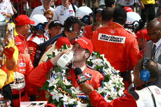Sam Hornish Jr. drinks the traditional winner's milk and wears the traditional vitory wreath after winning the 90th running of the Indianapolis 500. -- Photo by: Shawn Payne