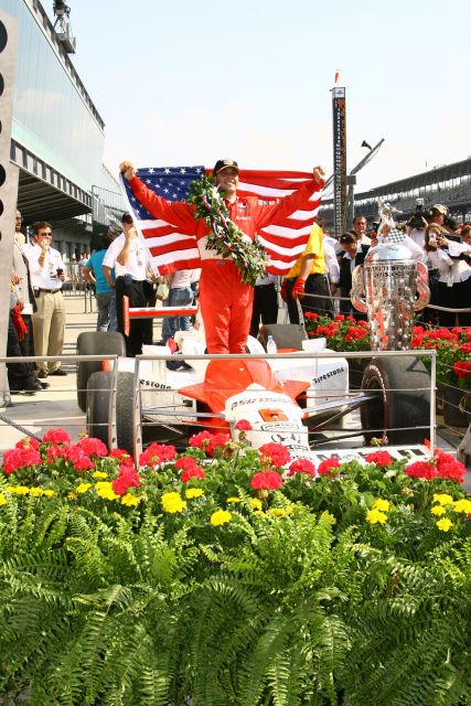 Sam Hornish Jr. brandishes the United States flag after winning the 90th running of the Indianapolis 500. -- Photo by: Shawn Payne