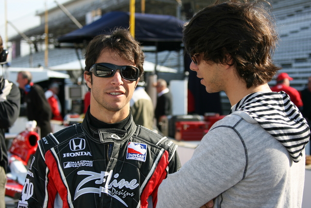 Bruno Junqueira and Mario Moraes talk in pit lane during practice at the Indianapolis Motor Speedway on Pole Day. -- Photo by: Chris Jones