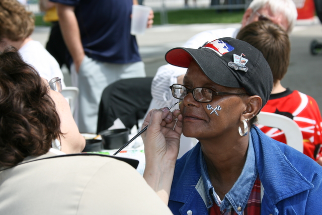 Fans get their faces painted during qualifications on Pole Day at the Indianapolis Motor Speedway. -- Photo by: Chris Jones