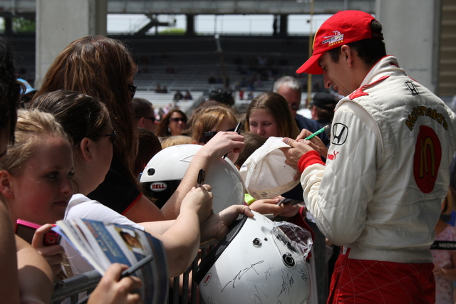 Justin Wilson signs autographs during qualifications on Pole Day at the Indianapolis Motor Speedway. -- Photo by: Dana Garrett