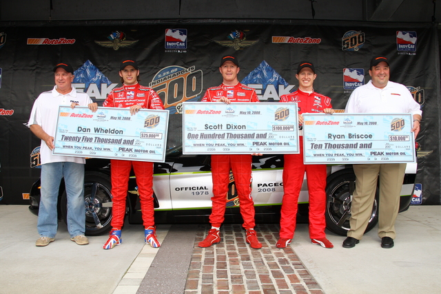 Dan Wheldon, Scott Dixon and Ryan Briscoe pose for photos with their checks after qualifications on Pole Day at the Indianapolis Motor Speedway. -- Photo by: Shawn Payne