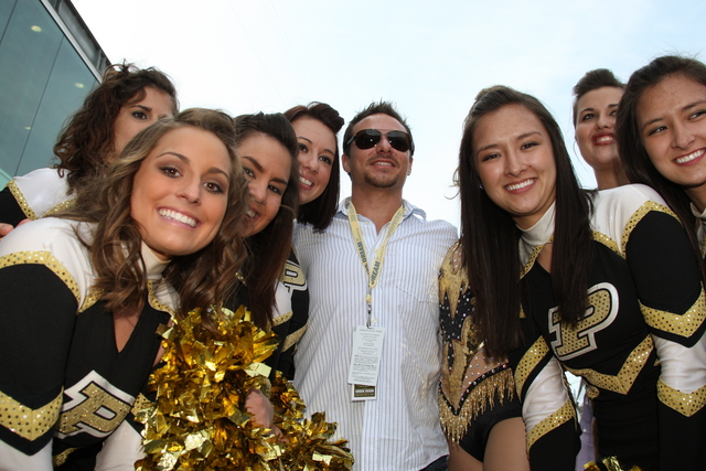 Singer Drew Lachey poses for photos with cheerleader on Race Day At the Indianapolis Motor Speedway. -- Photo by: Dana Garrett