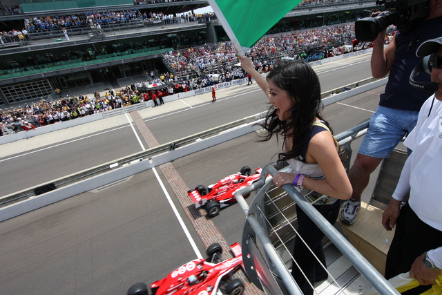 Kristi Yamaguchi waves the green flag on Race Day At the Indianapolis Motor Speedway. -- Photo by: Ron McQueeney