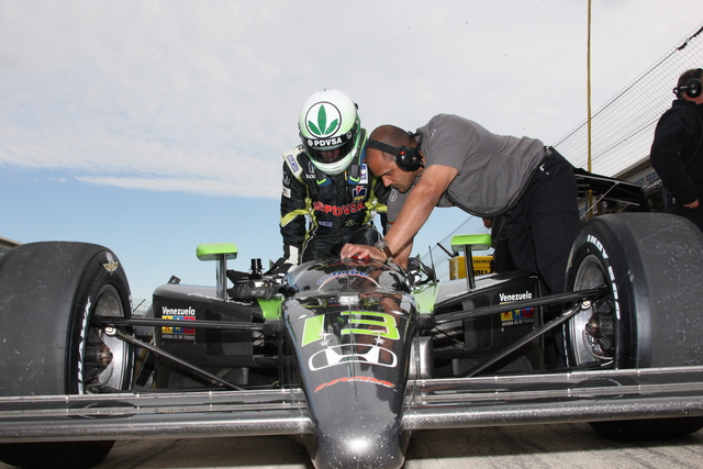 EJ Viso climbs into his IndyCar -- Photo by: Chris Jones