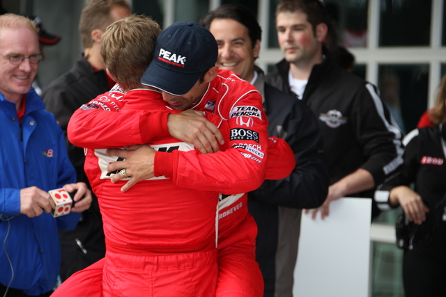 Helio Castroneves (with hat) is congratulated by teammate Ryan Briscoe. -- Photo by: Dana Garrett