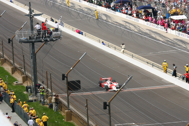 Helio Castroneves crosses the finish line to win the Indianapolis 500. -- Photo by: Bret Kelley