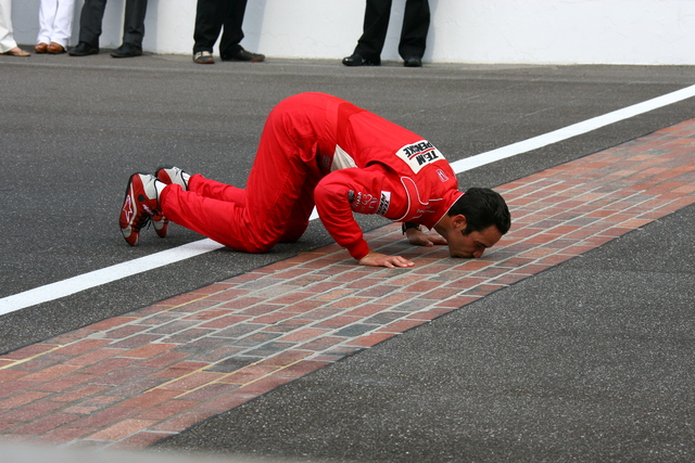 Helio Castroneves kisses the bricks for the third time. -- Photo by: Bret Kelley