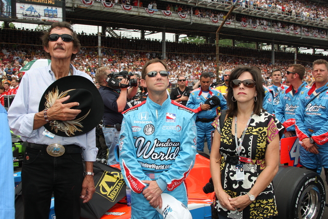Richard Petty, left, and John Andretti with his wife during the national anthem. -- Photo by: Chris Jones