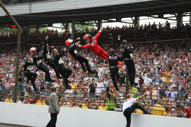 Helio Castroneves celebrates the race victory in his special style. -- Photo by: Jim Haines