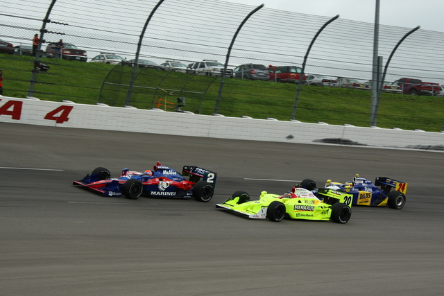 The cars of Ed Carpenter (20), Raphael Matos (2) and Mike Conway (24) race in Turn 4. -- Photo by: Jim Haines