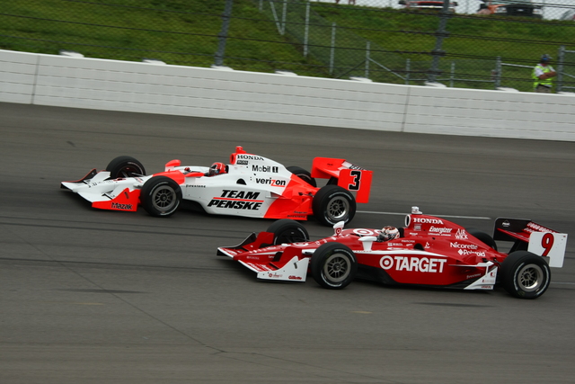 The cars of Scott Dixon (9) and Helio Castroneves race into Turn 1. -- Photo by: Jim Haines
