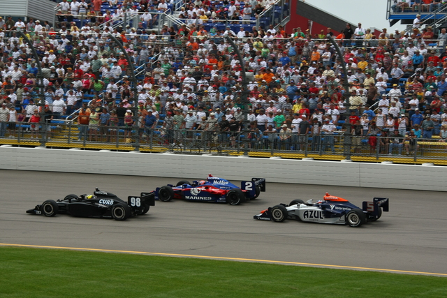 The cars of Jaques Lazier (98), Raphael Matos (2) and Mario Moraes (5) race into Turn 1. -- Photo by: Jim Haines