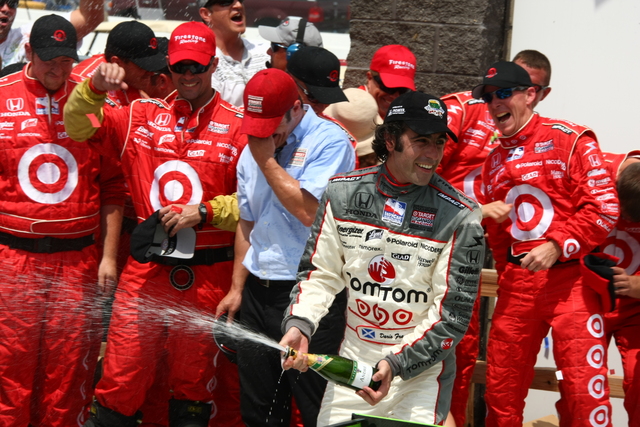 Dario Franchitti celebrates his victory with teammates. -- Photo by: Jim Haines
