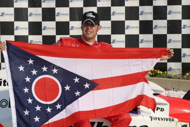 Sam Hornish Jr. celebrates his victory, displaying the Ohio state flag. -- Photo by: Chris Jones