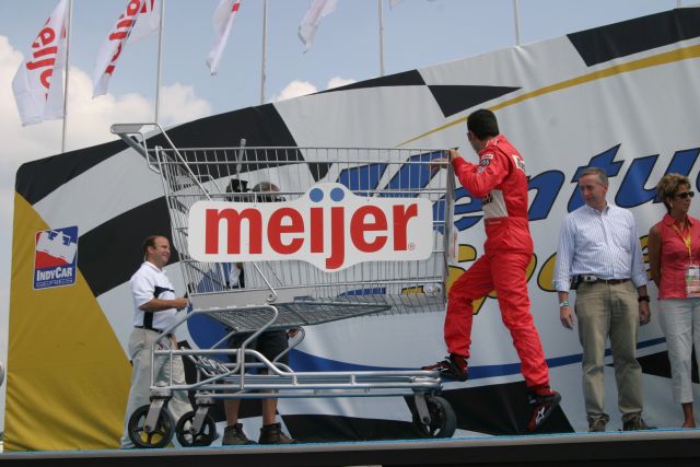 Helio Castroneves climbs on the giant Meijer shopping cart during driver introductions at Kentucky. -- Photo by: Chris Jones