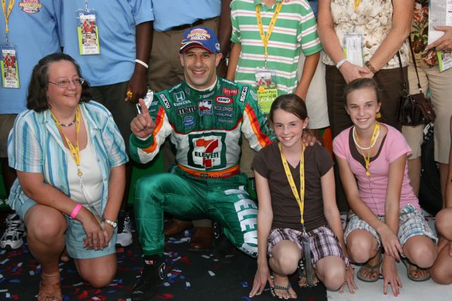 Tony Kanaan poses with kids after winning the Meijer Indy 300 at Kentucky Speedway. -- Photo by: Dana Garrett