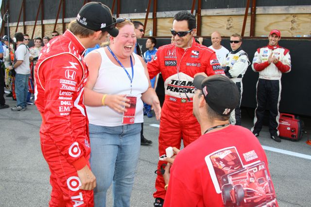 Dan Wheldon and Helio Castroneves help a man propose to his girlfriend at the Kentucky Speedway on race day, -- Photo by: Shawn Payne