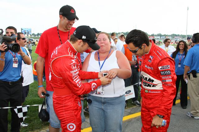 Dan Wheldon and Helio Castroneves check out the ring after helping a man propose to his girlfriend at the Kentucky Speedway on race day. -- Photo by: Shawn Payne