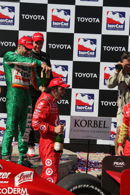 Dario Franchitti is cooled off by Tony Kanaan in Victory Lane. -- Photo by: Chris Jones