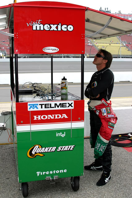 Adrian Fernandez watches team monitors during practice session -- Photo by: Chris Jones