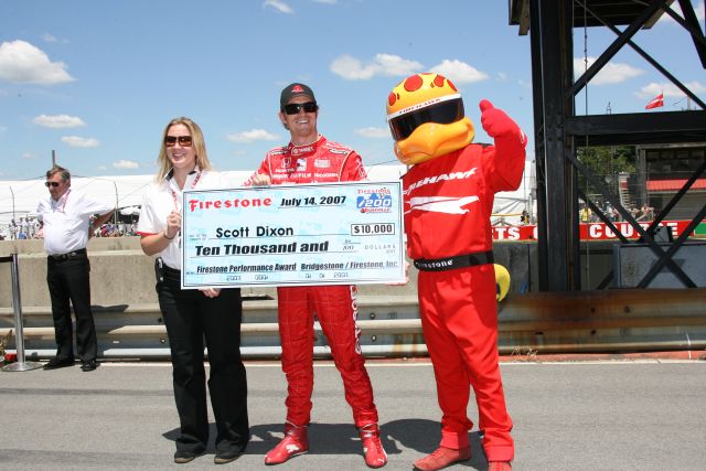 Scott Dixon gets a check for the Firestone Performance Award before the Honda 200 at Mid-Ohio. -- Photo by: Chris Jones