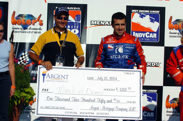 Andretti Green driver Dario Franchitti, right, with winner check. -- Photo by: Jim Haines