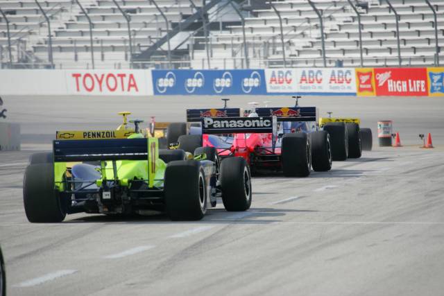 Indycars exiting pit lane -- Photo by: Ron McQueeney